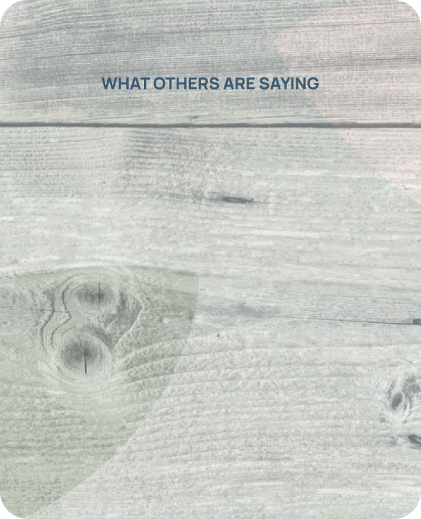 A light-colored wooden surface with blue text that reads "What others are saying".