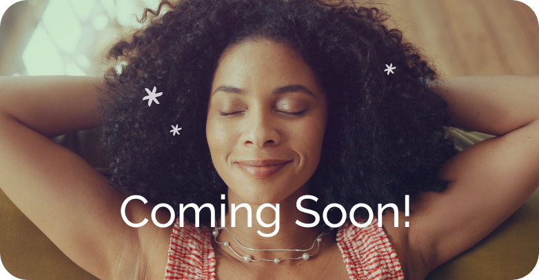 A woman with curly hair relaxing with her eyes closed and a content smile on her face, overlaid with the text "Coming Soon!"