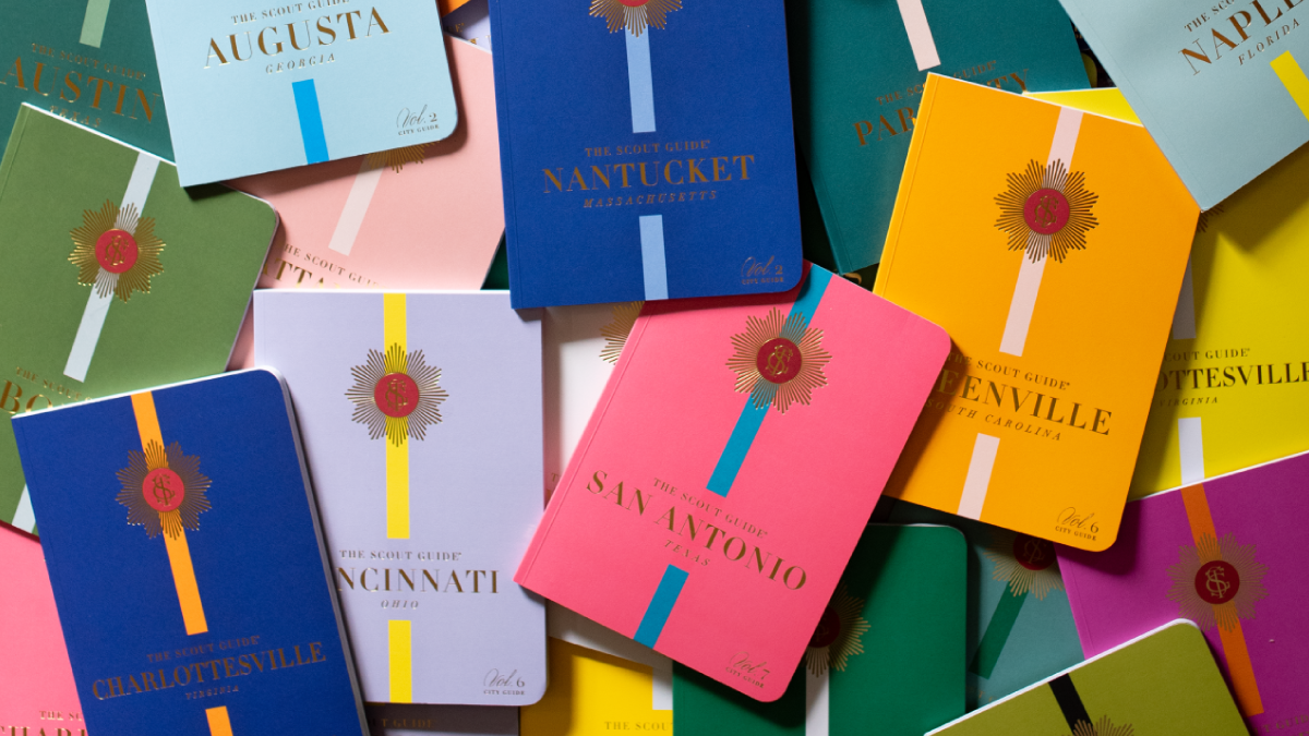 Colorful Scout Guide books for various cities, including Atlanta, Nantucket, Charlotteville, San Antonio, Nashville, and others, with bright covers in various colors and a badge-like emblem on each.