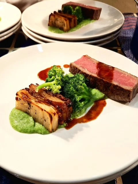 Plate with seared tuna, broccoli, and grilled Okonomiyaki with sauce, on a white plate.