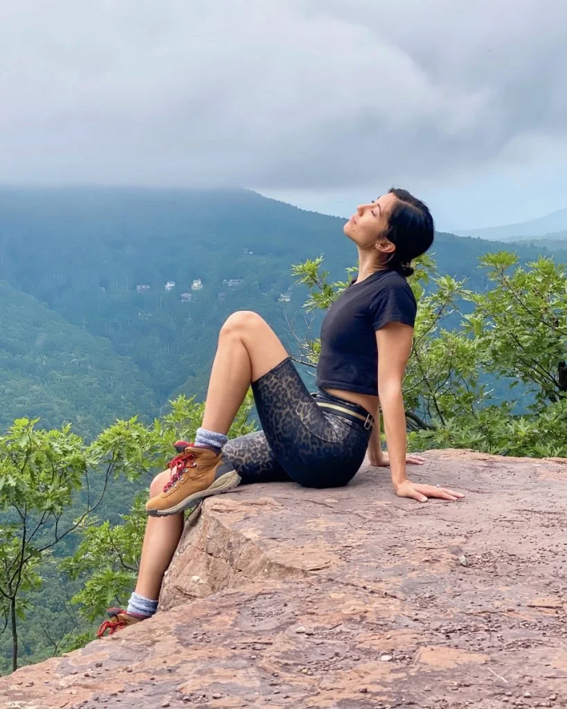 woman daydreaming on top of mountain view
