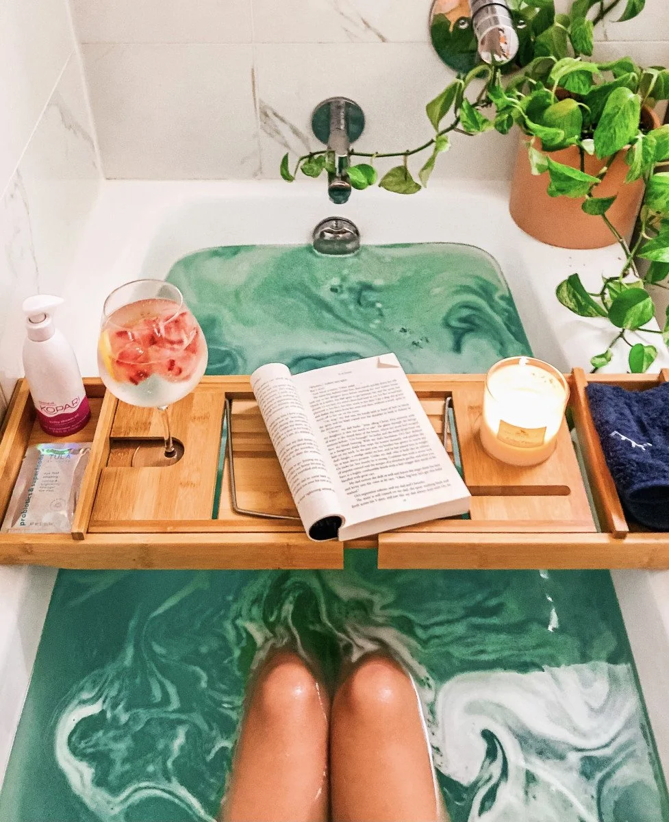 relaxation in a bath with book and drink