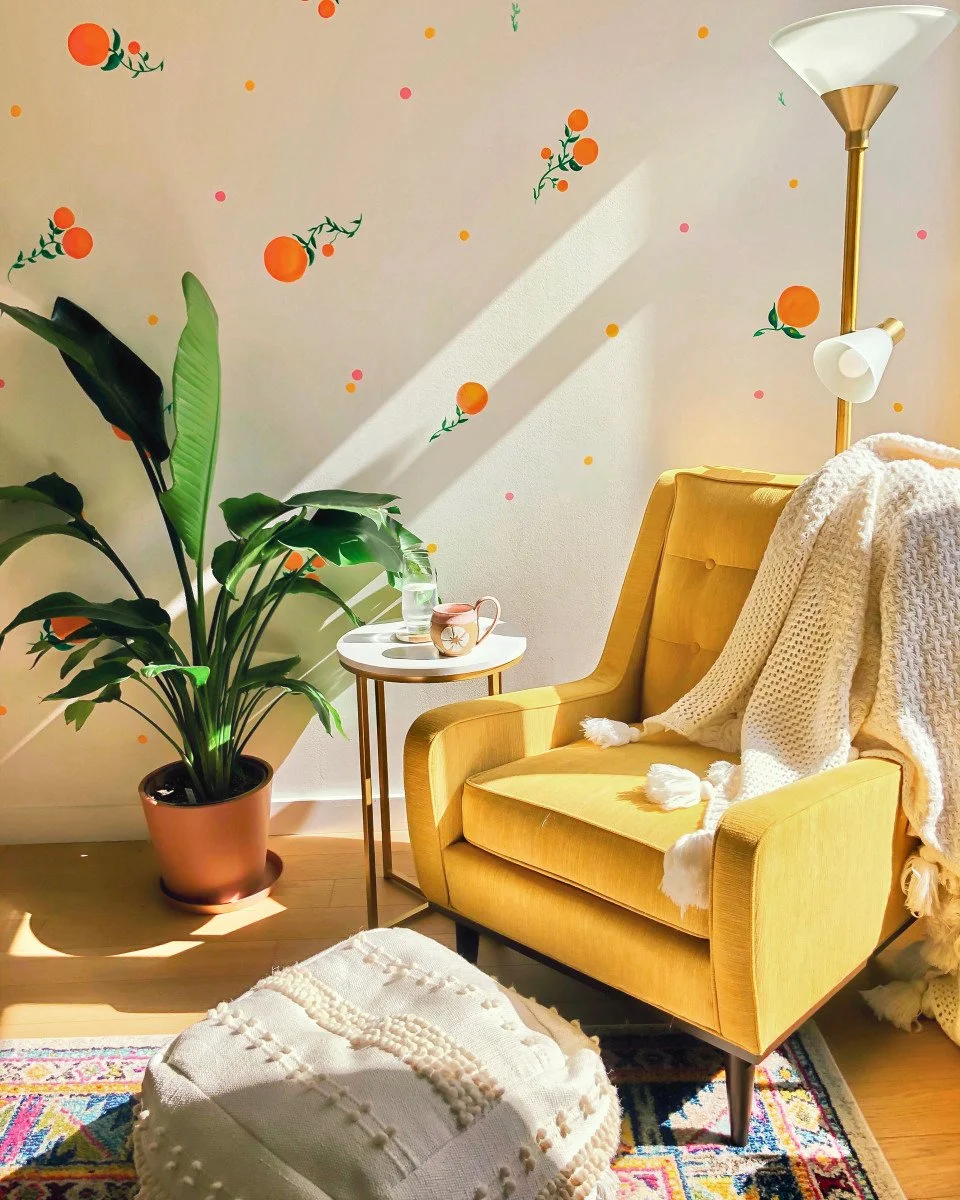 walls with oranges and yellow chair with plant