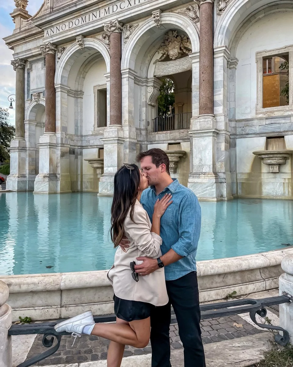 husband and wife kissing in rome