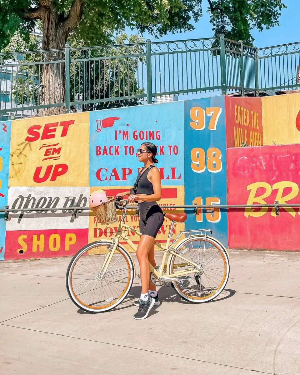woman standing with bike