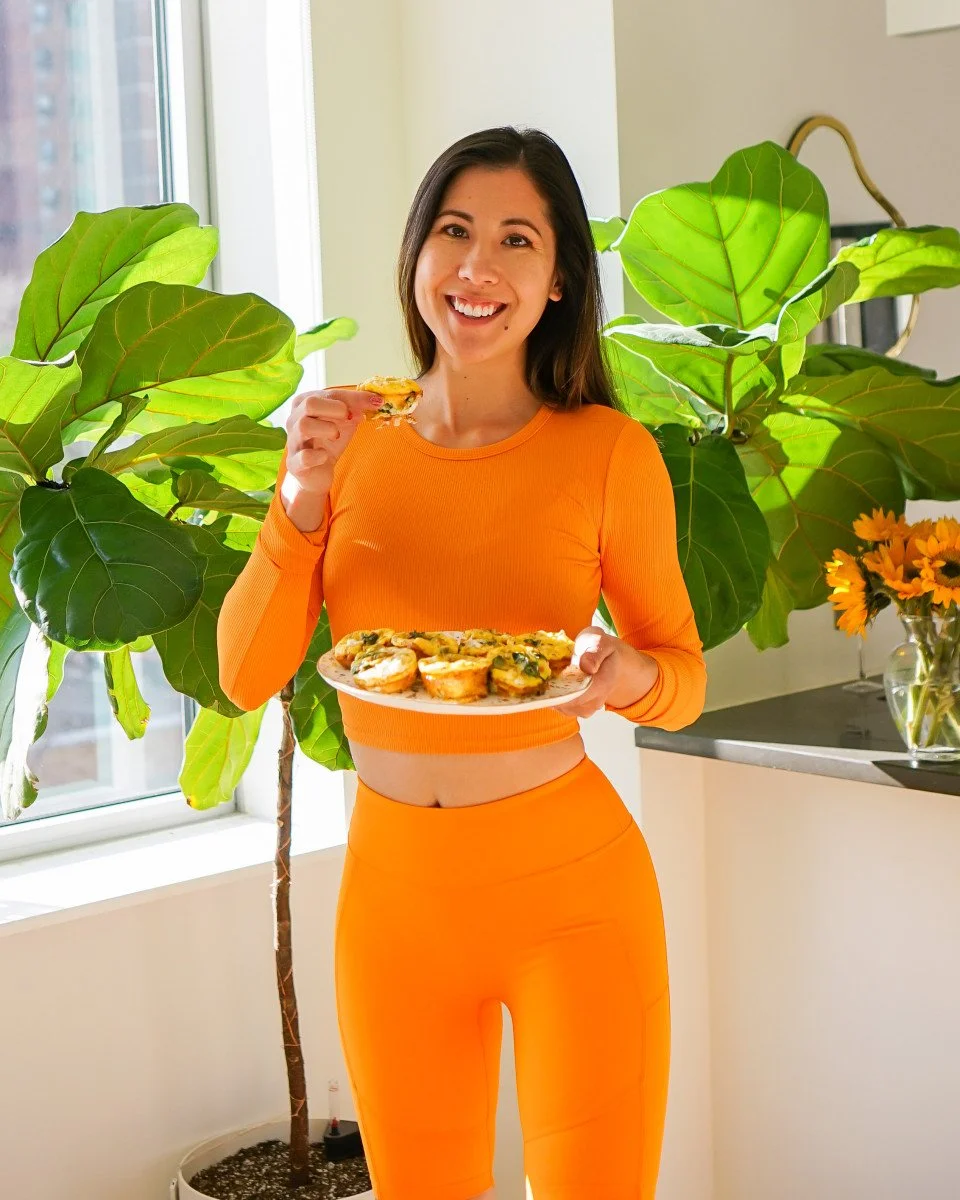 woman holding quiche bites