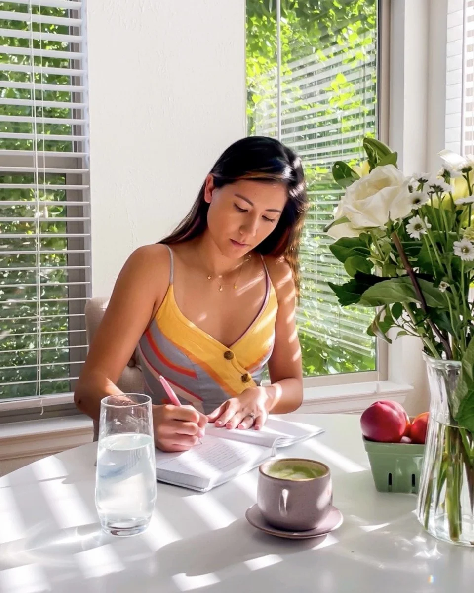 woman journaling at table