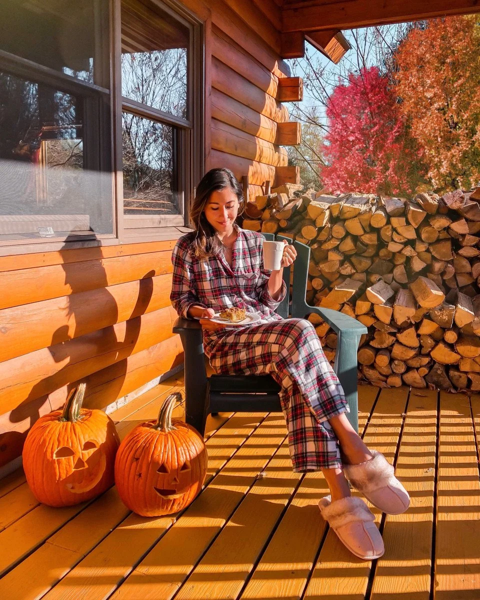 woman in plaid pajamas eating breakfast outside