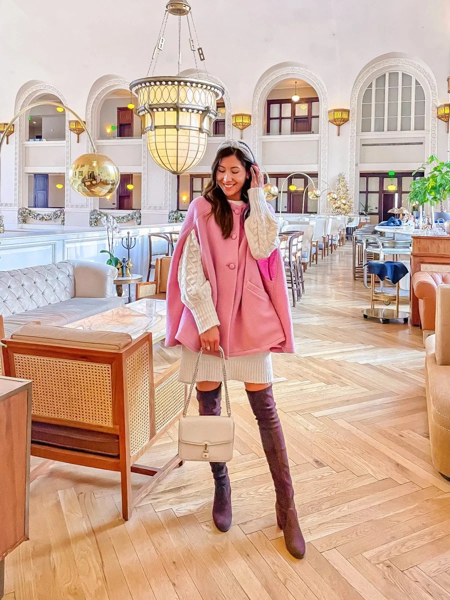woman in pink cape and sweater