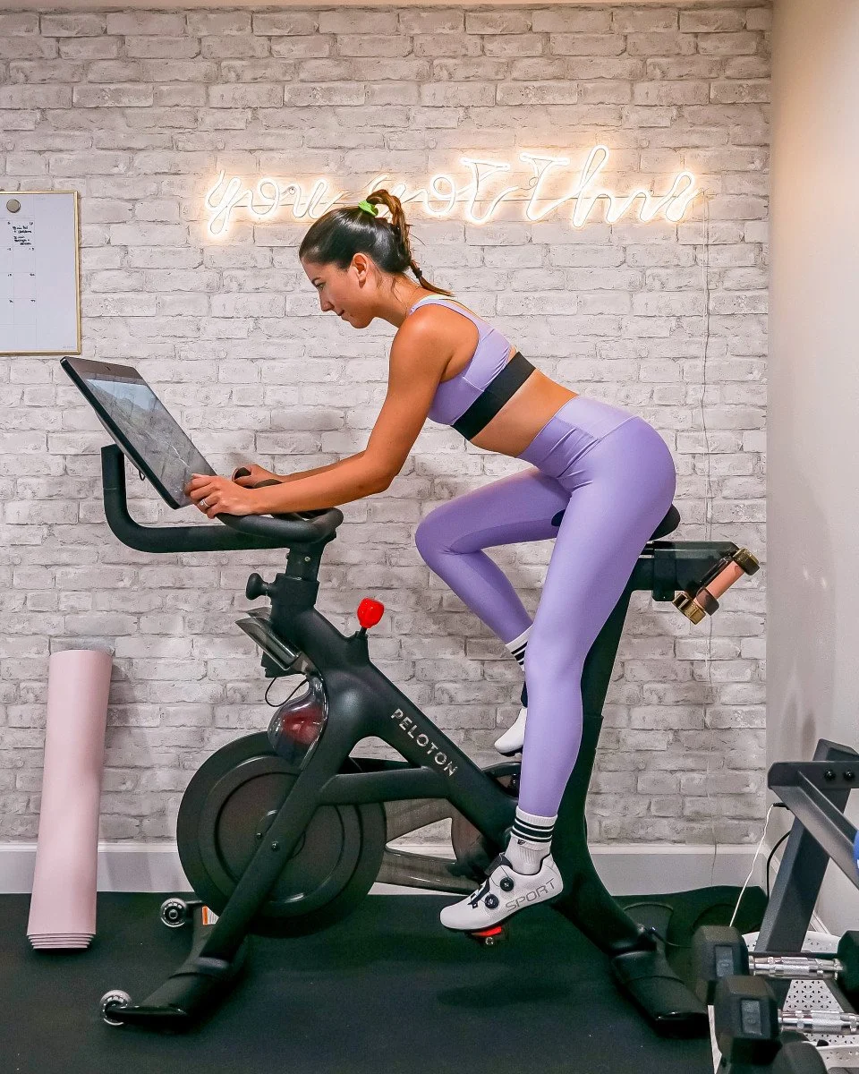woman riding a peloton bike