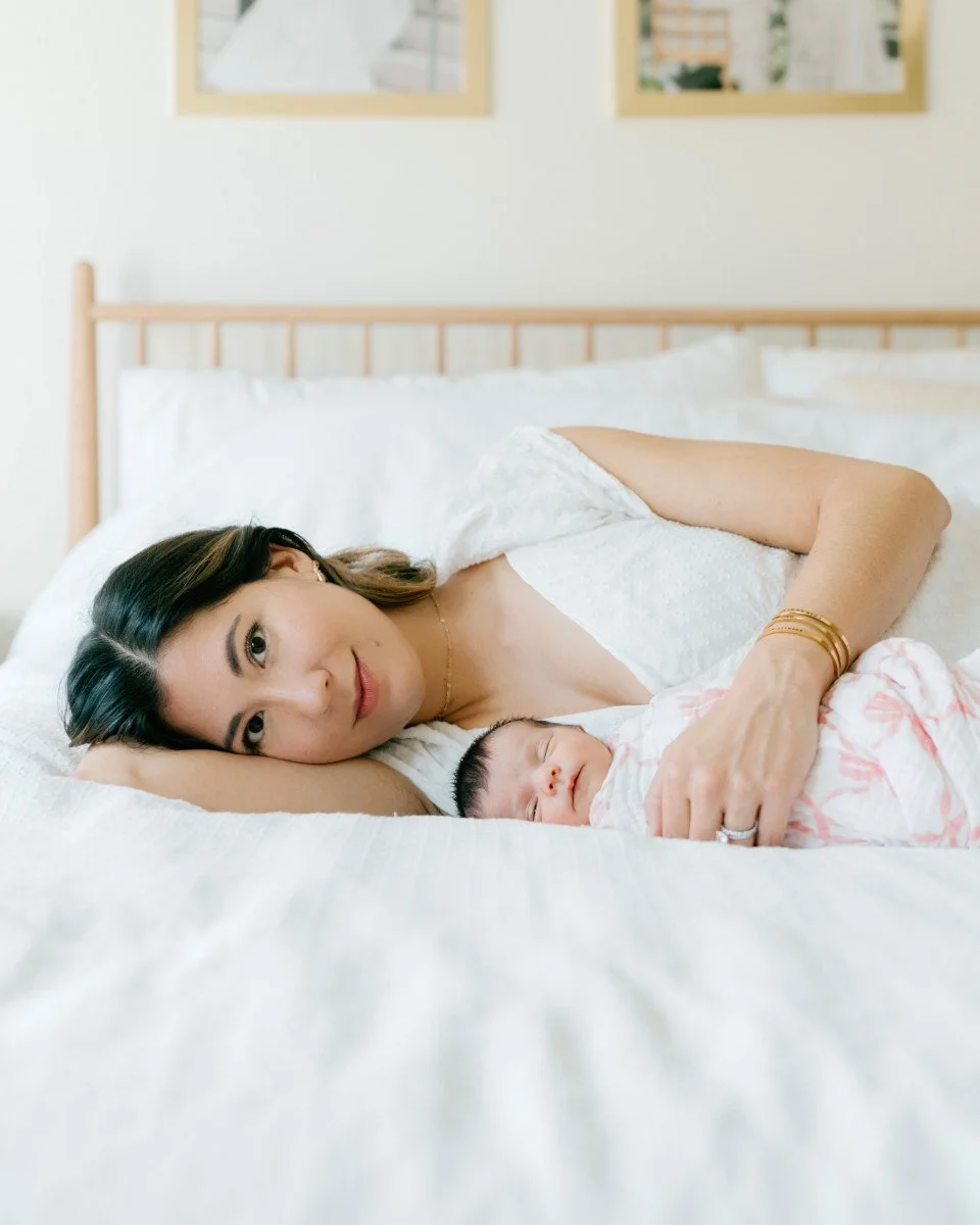newborn girl and mom on bed