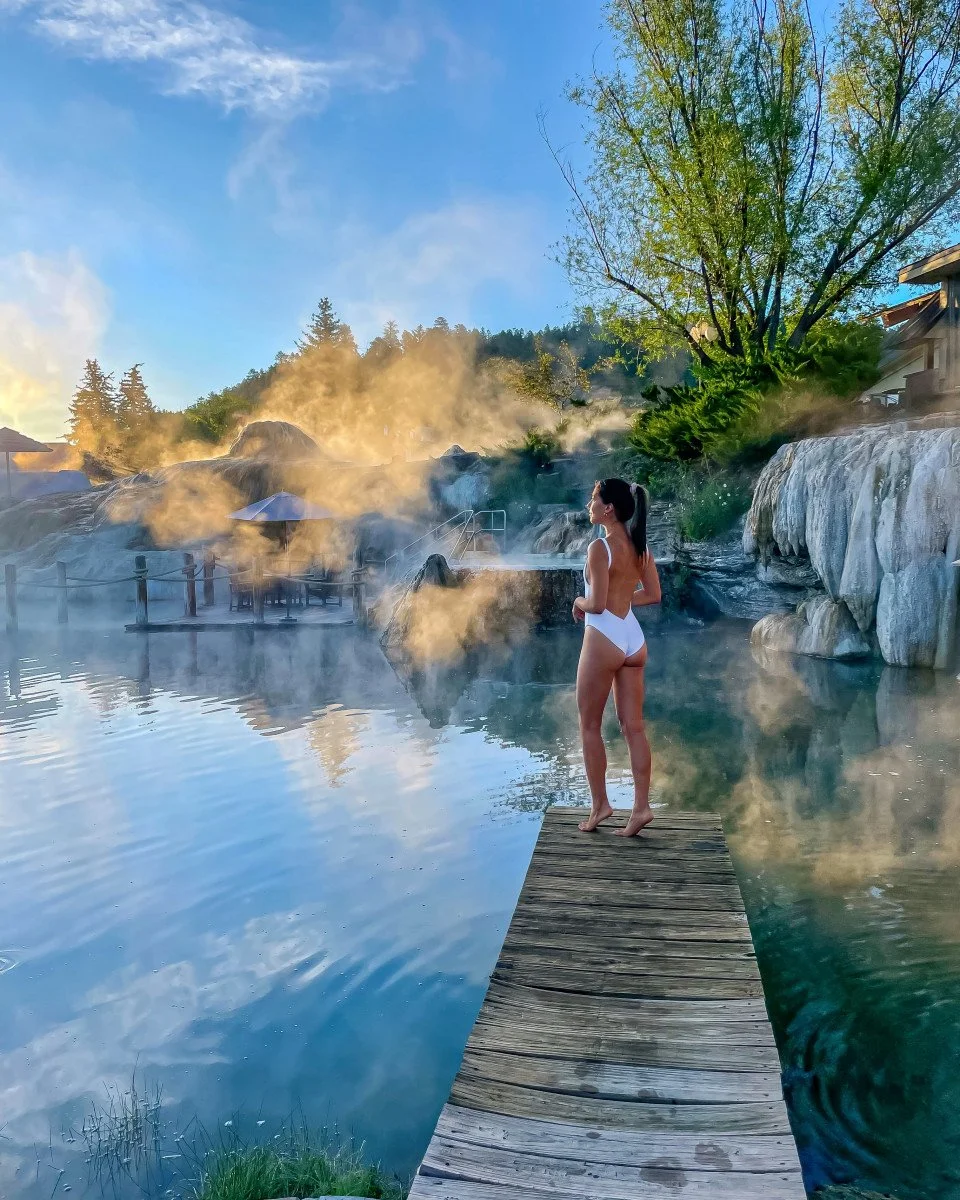 woman standing on dock at hot spring