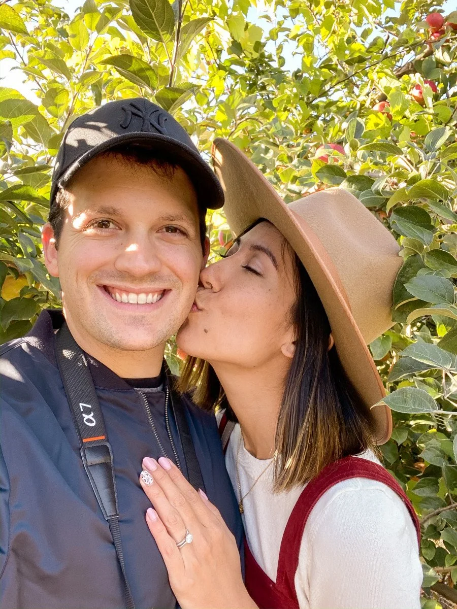 couple kissing photo in orchard