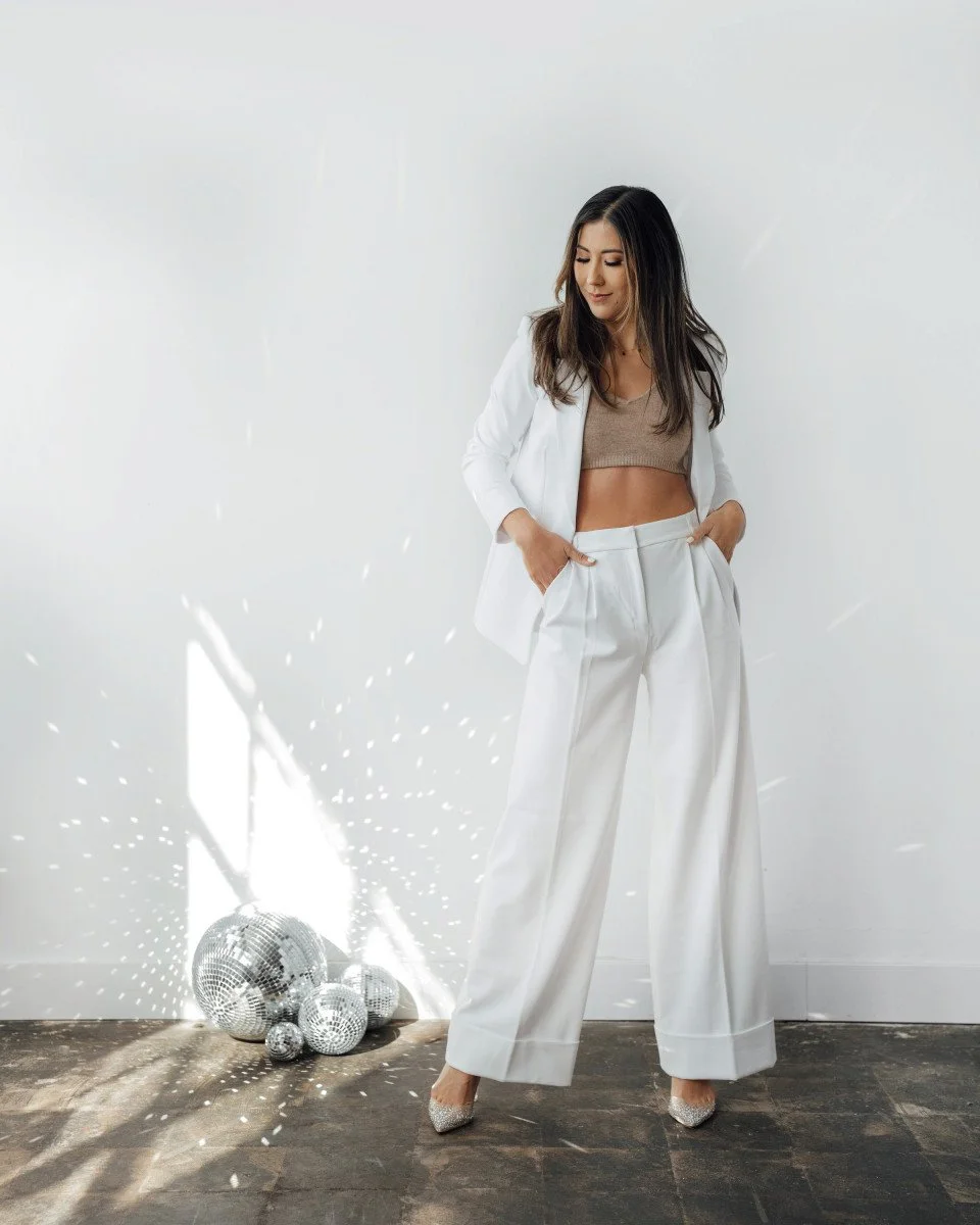 woman posing with disco balls