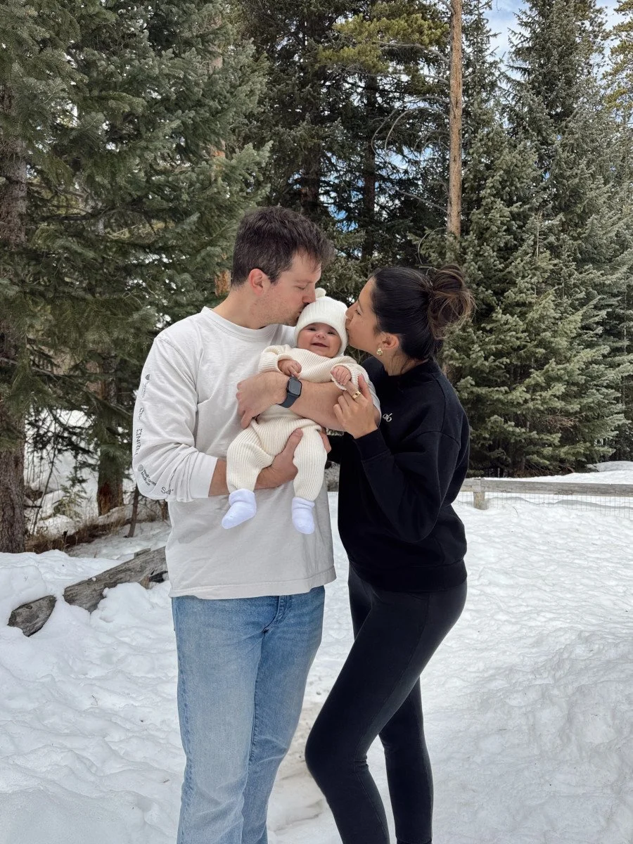 couple kissing baby