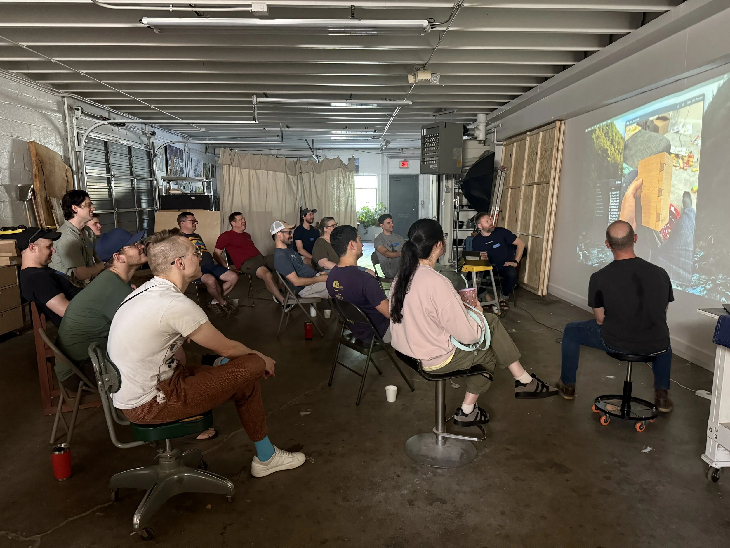 Scenic landscape of a lake surrounded by rolling hills and mountains under cloudy sky.