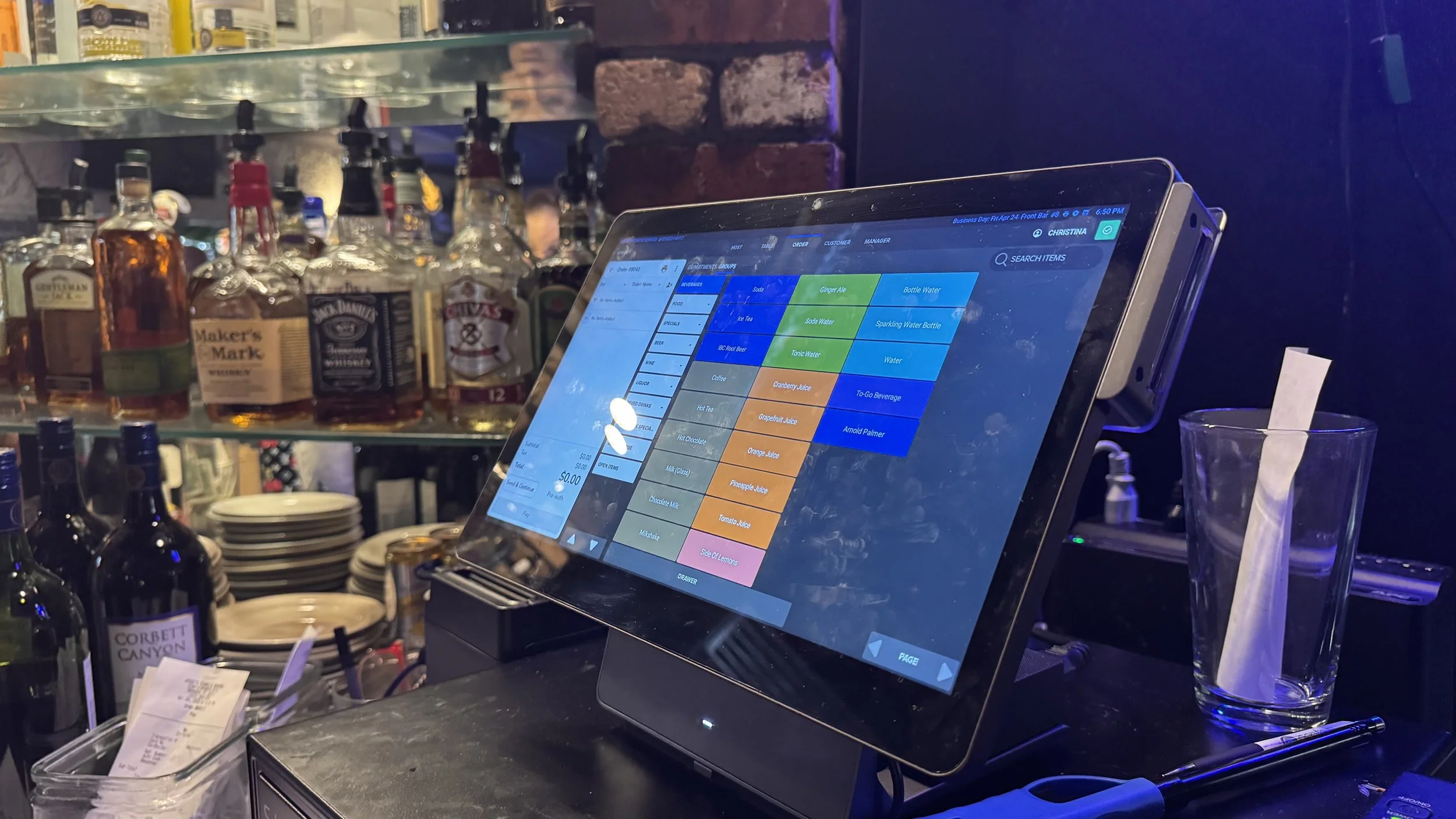 SkyTab POS station, in a restaurant bar, displaying the menu on screen.