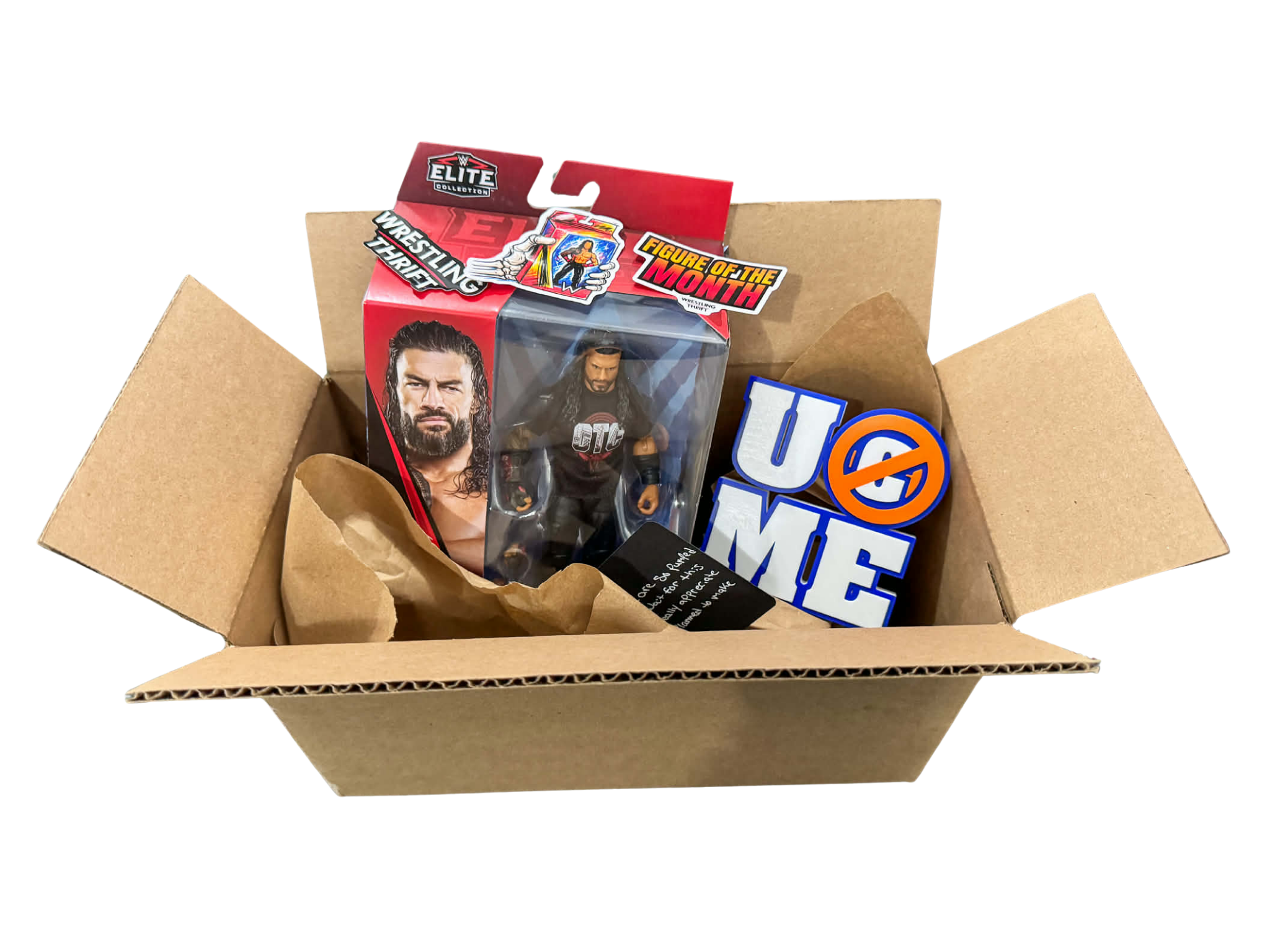Open cardboard box containing WWE collectible action figures and promotional stickers.