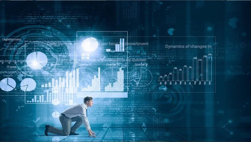 An executive analyzing futuristic digital data displays, symbolizing leadership guiding teams through digital transformation and AI adoption.