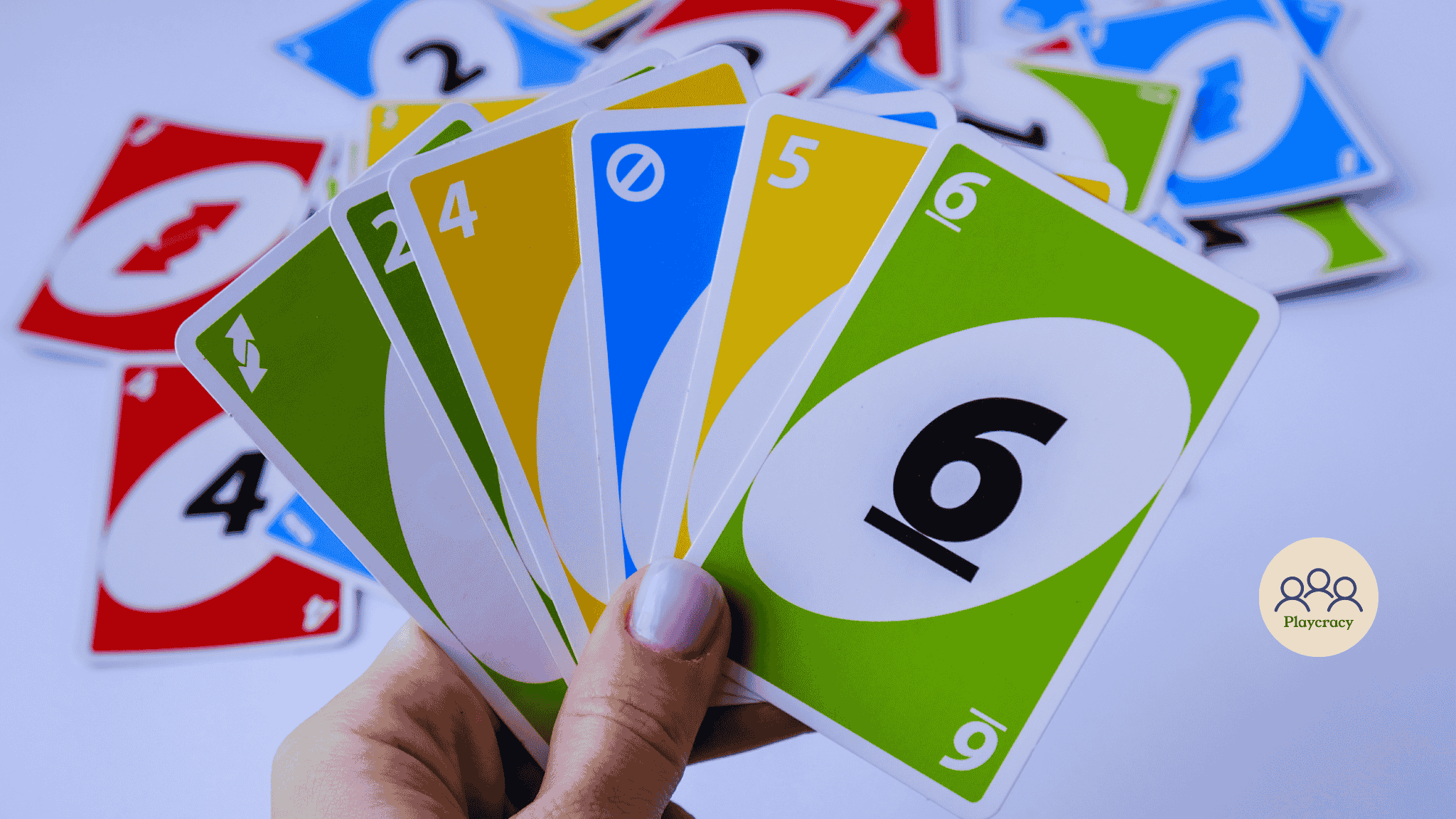 Hand holding UNO cards of different colors