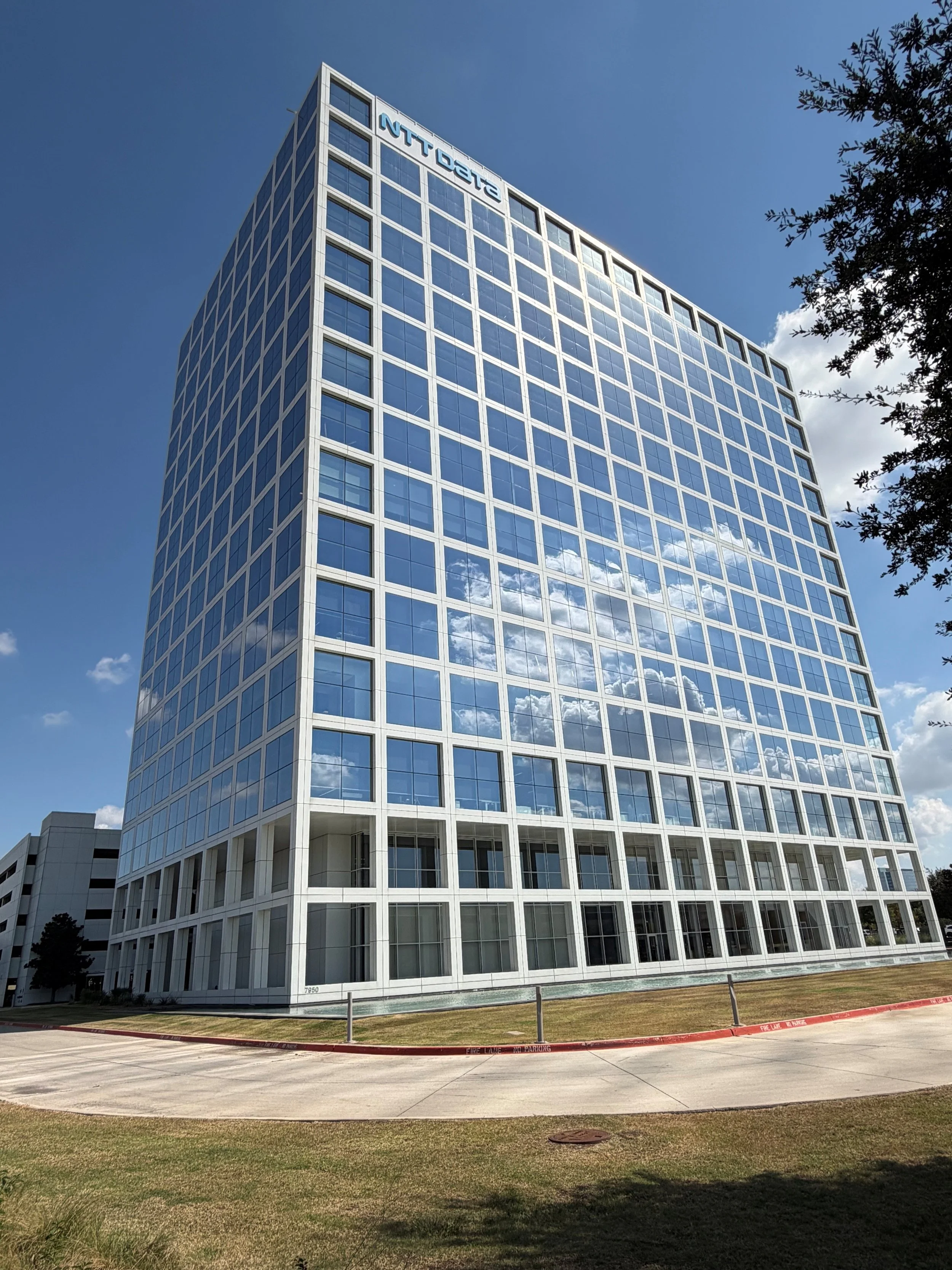 A modern, multi-story corporate office facility featuring a sleek glass façade and contemporary architectural design. Built to support large-scale enterprise operations with a clean, professional presence.