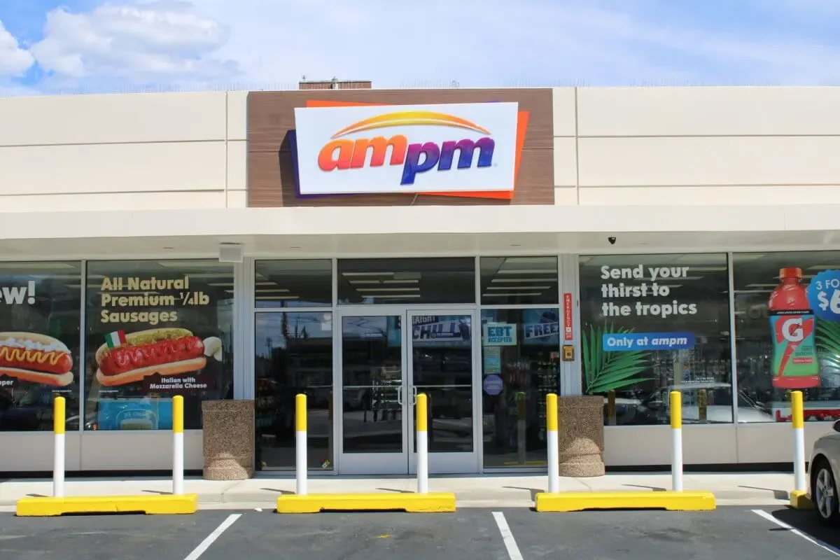 A contemporary convenience store designed for high-volume customer flow and visibility. Features prominent branding, modern exterior materials, and a layout optimized for quick service retail.