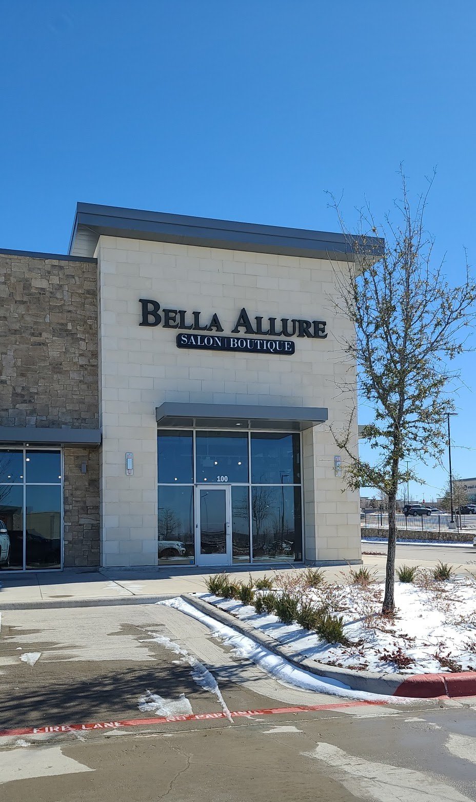 A stylish commercial storefront combining stone and modern paneling to create a welcoming, upscale aesthetic. Designed to support boutique retail and salon services with strong curb appeal.