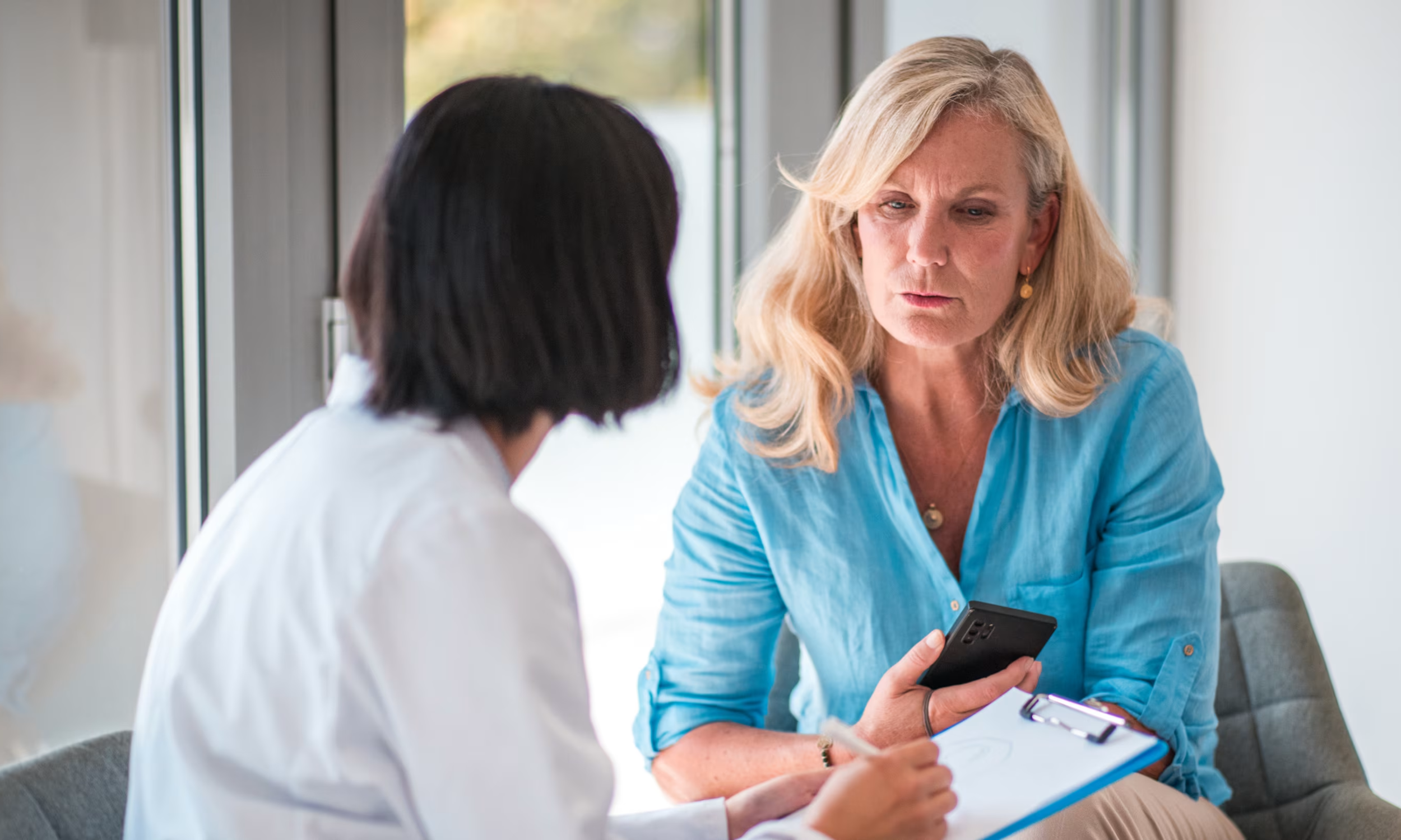 Woman in Fort Mill, SC discussing perimenopause symptoms with her doctor