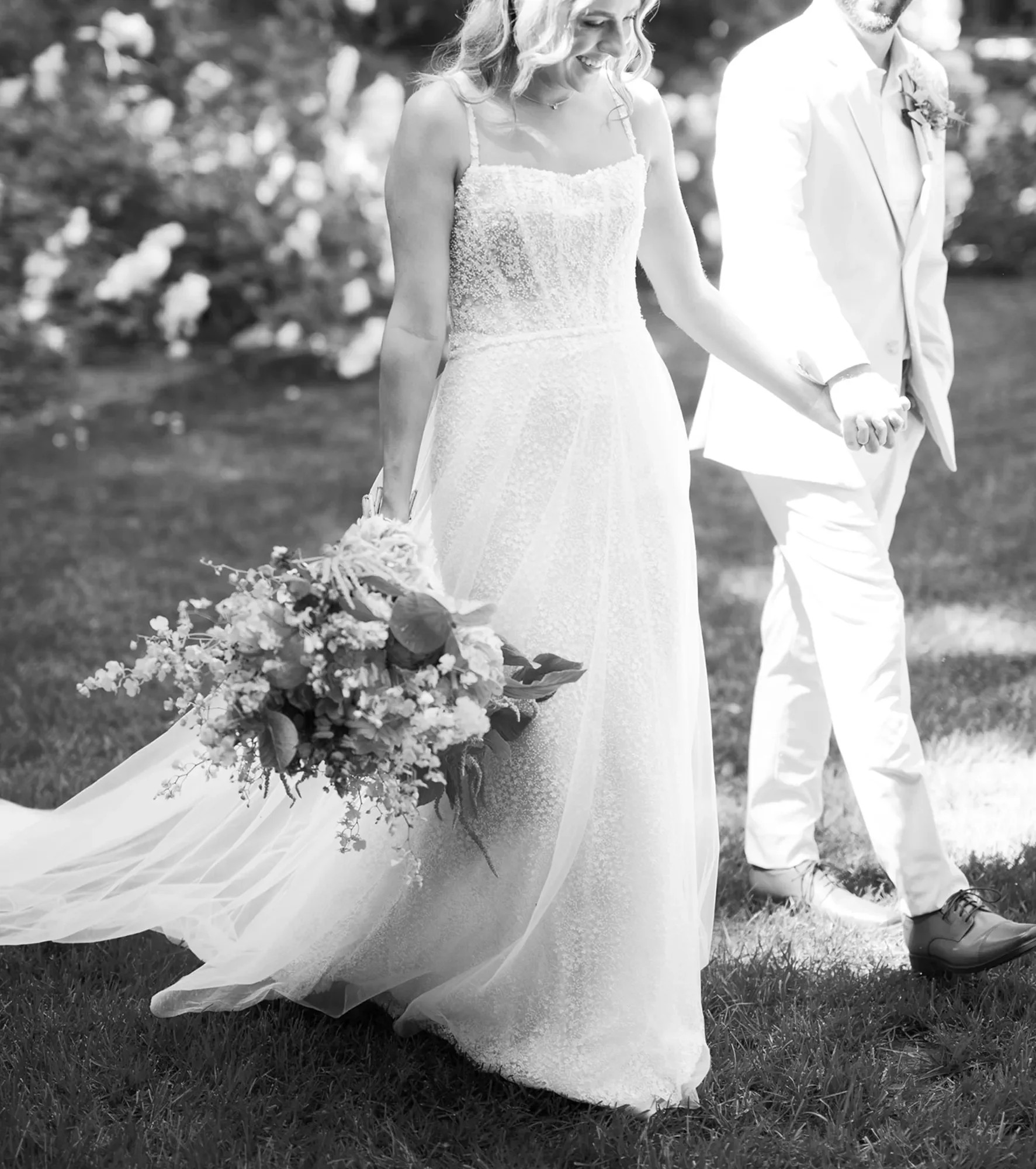 Lizzeth Mendoza Photography photographing a candid moment of the bride and groom walking through their Palm Springs inspired wedding at The Palms in Chico, California.