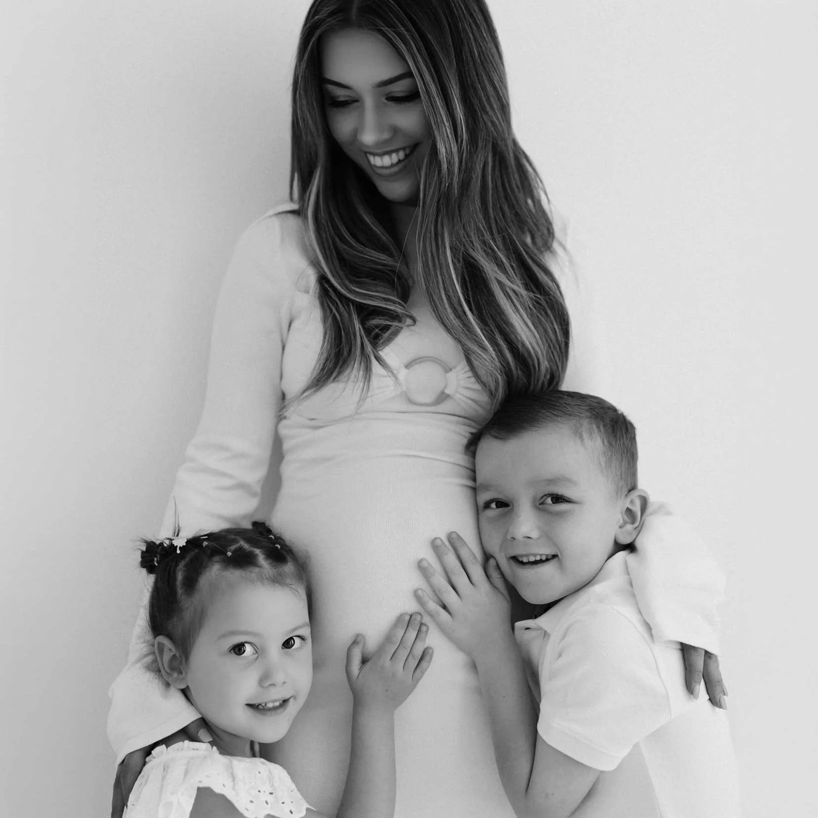 Black and white photo of Hayley Petheram with her two children.