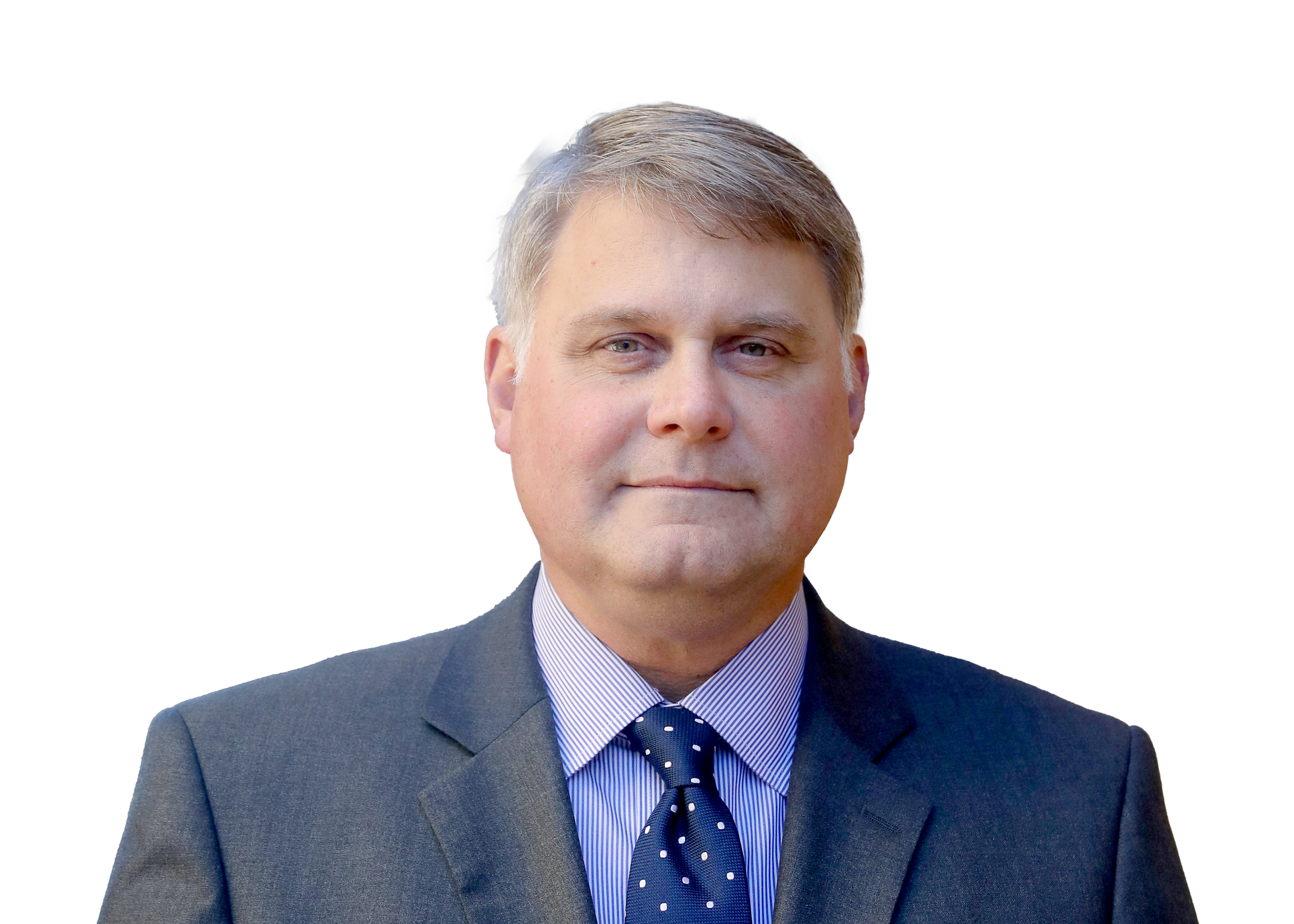 Christopher has short gray hair and blue eyes, with a gray suit jacket and navy tie with white dots