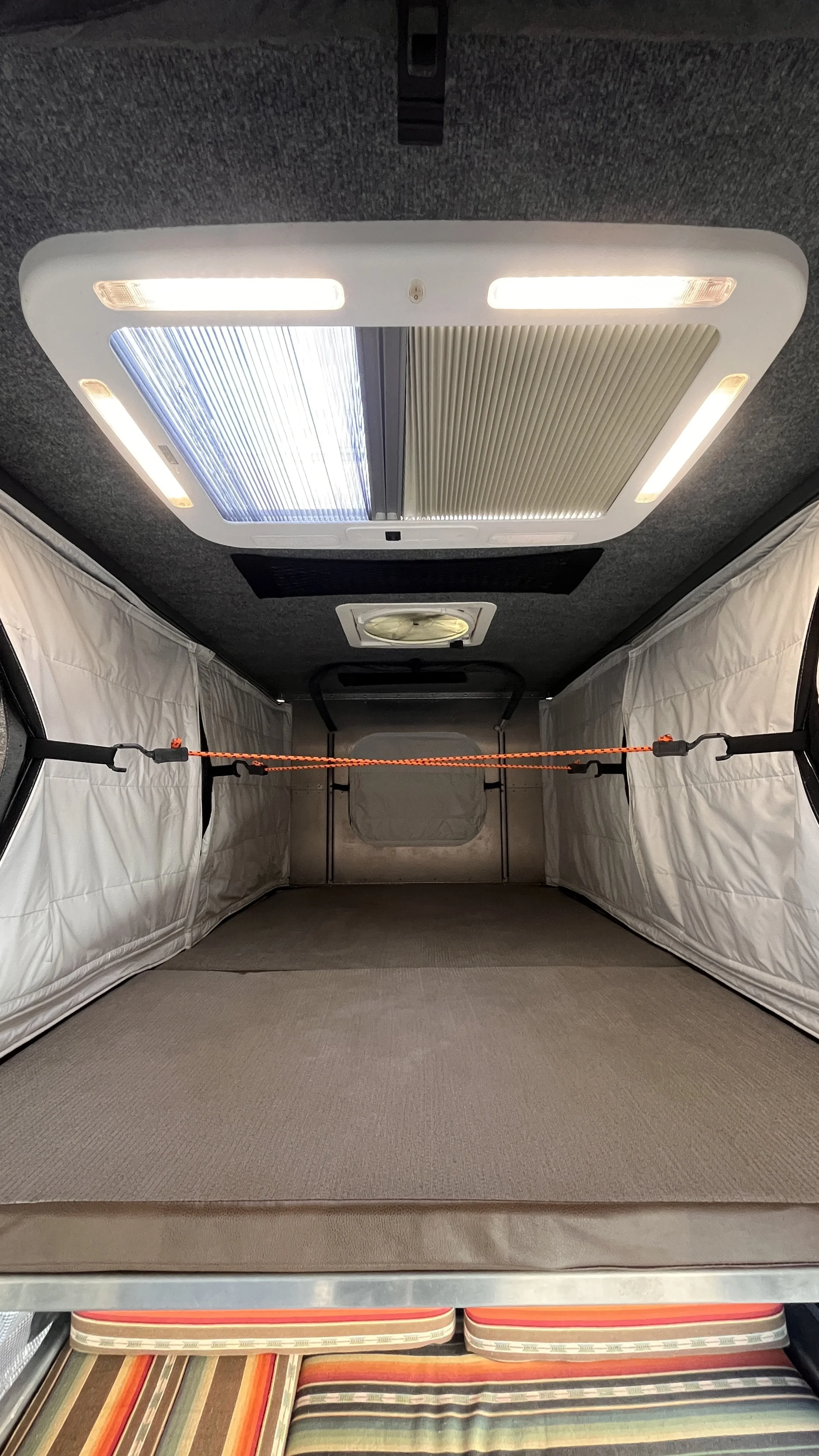 roof hatch with light on and screen and blackout shade