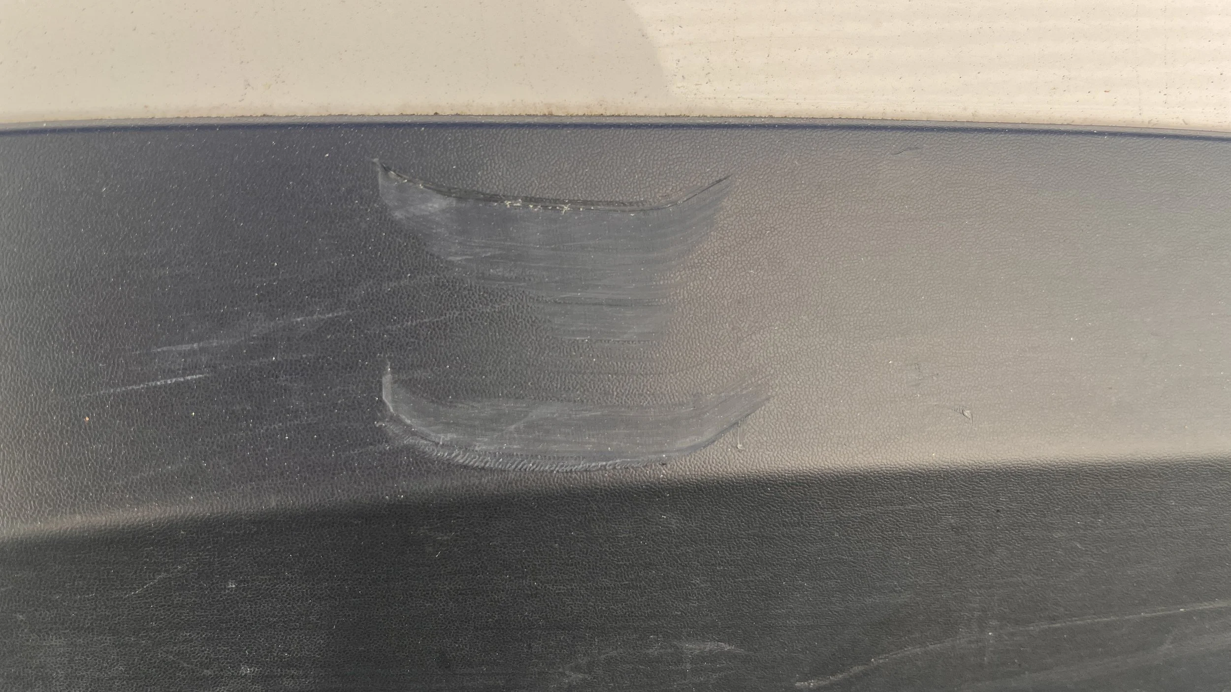 Passenger sides wheel well cover scuff