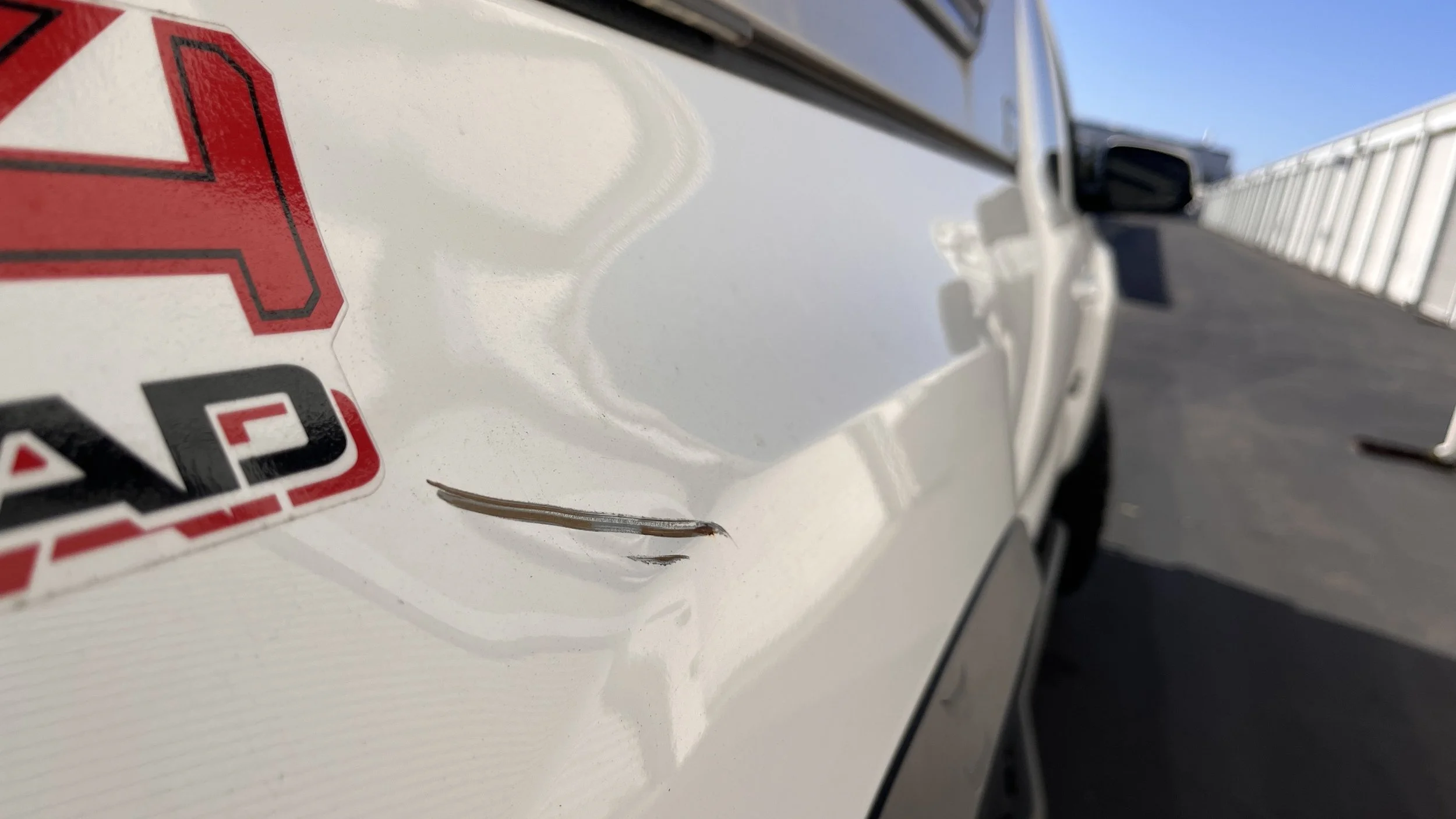 rear passenger side scuff/dent