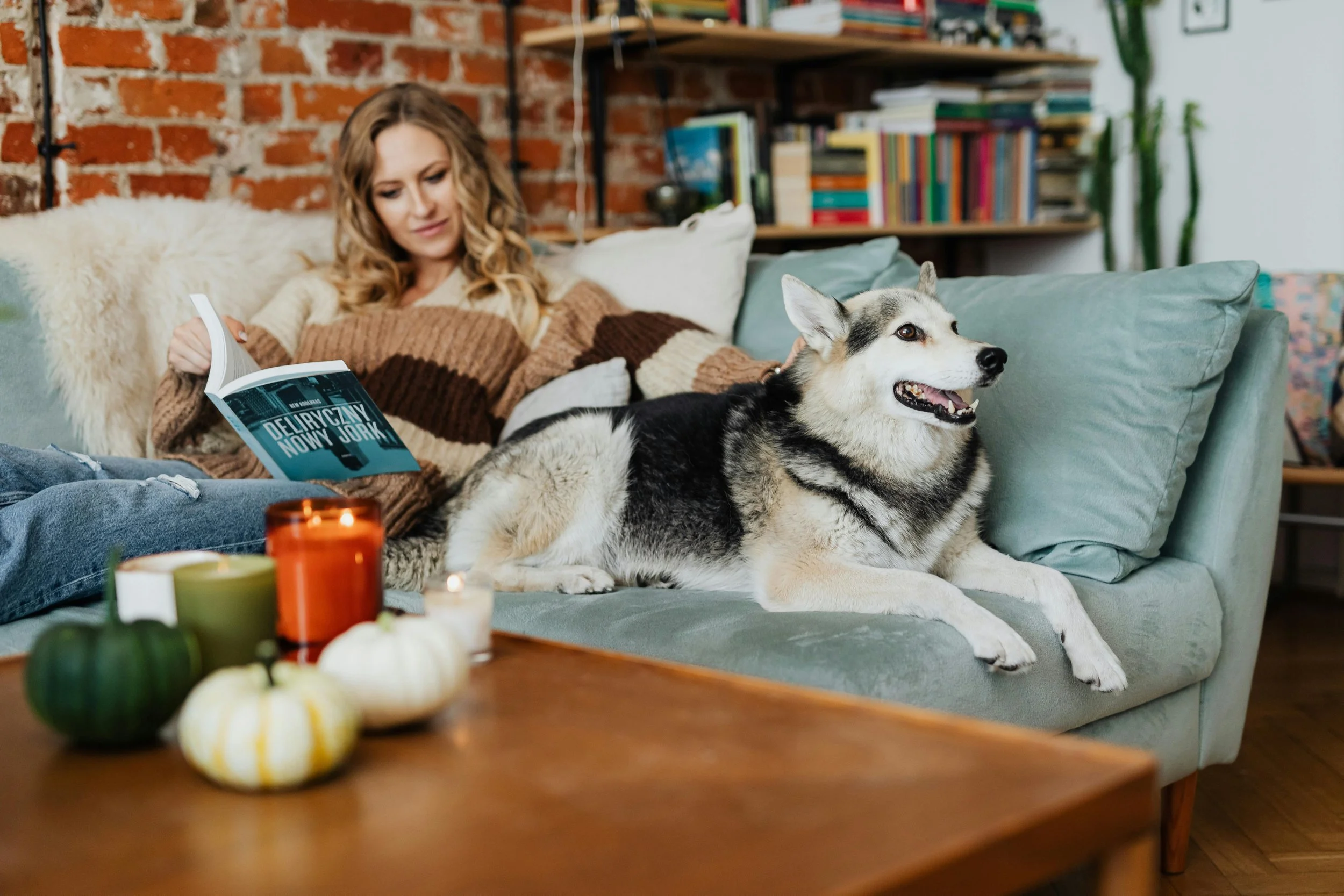 a woman and dog on a couch