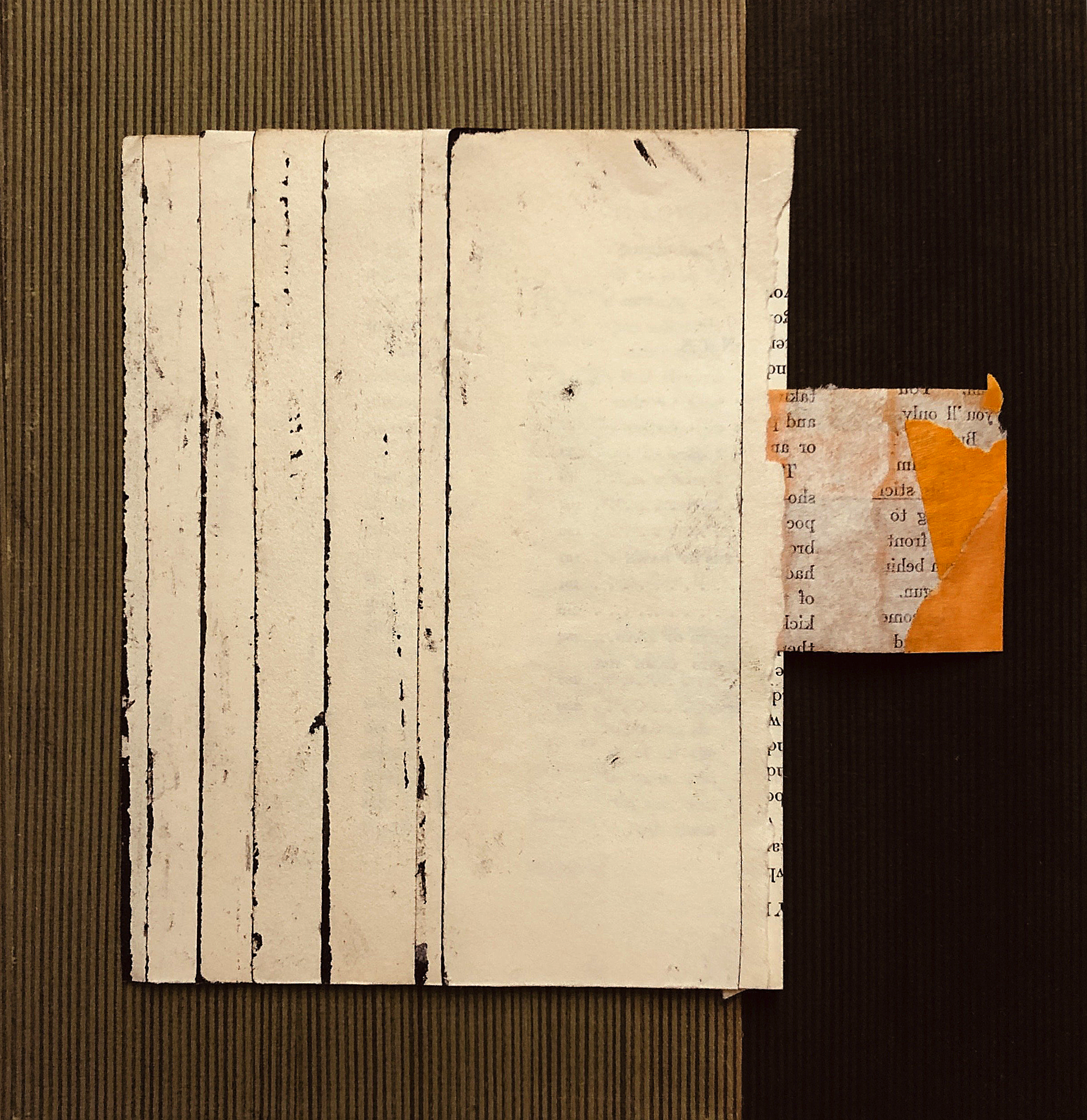 A collage of torn paper pieces with printed text, arranged on a dark striped background.