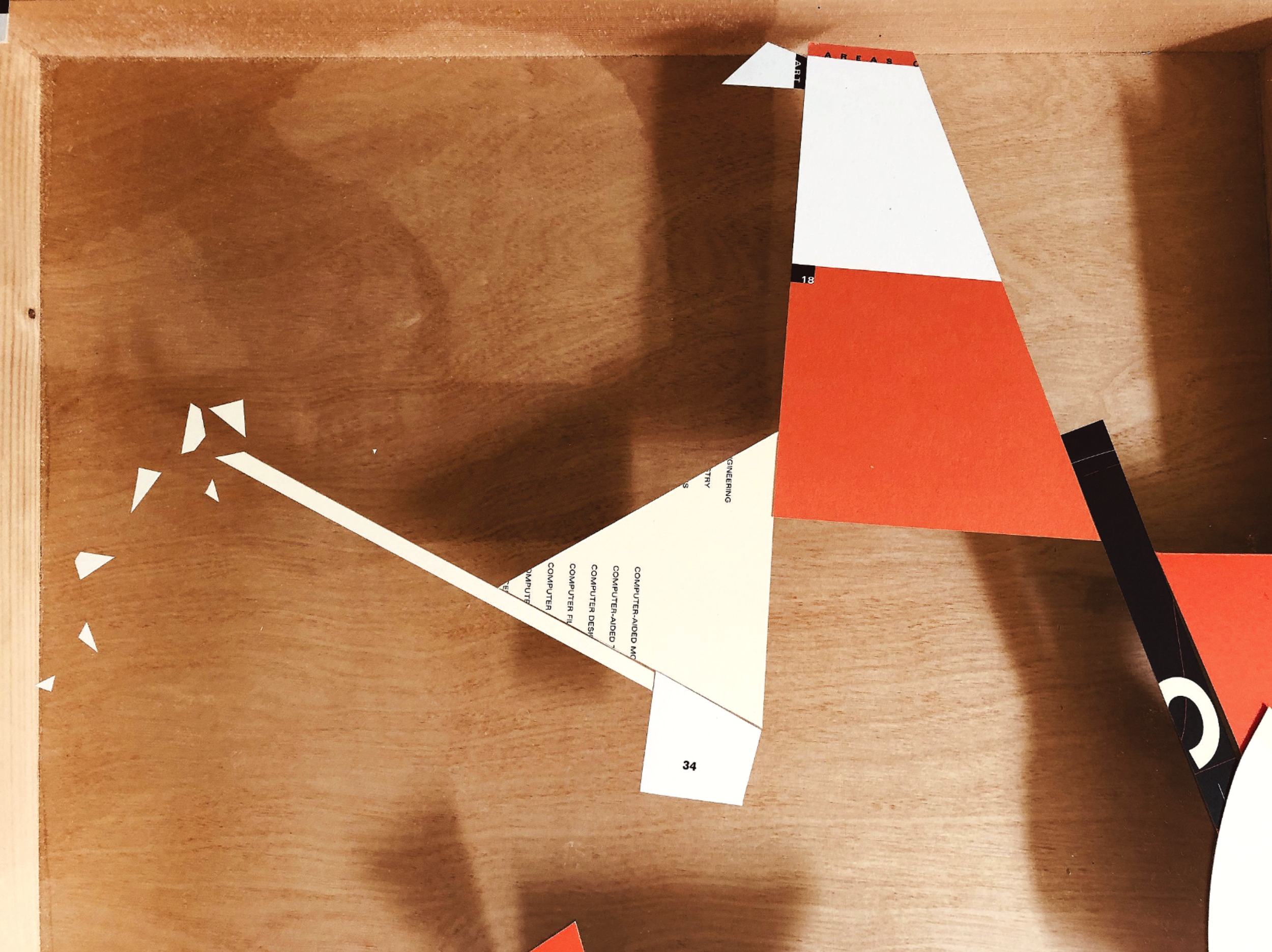 Collage of paper pieces with partial text and numbers on a wooden surface, with some torn edges and geometric shapes in white, orange, and black.