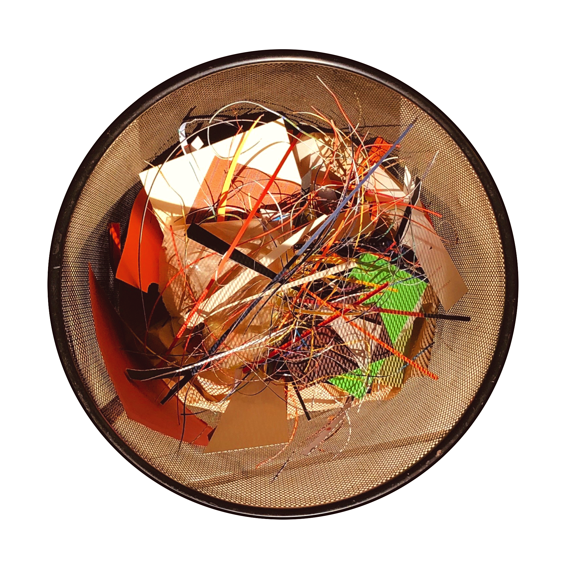 A top-down view of a wastebasket filled with crumpled papers, colored paper strips, and paper clips.