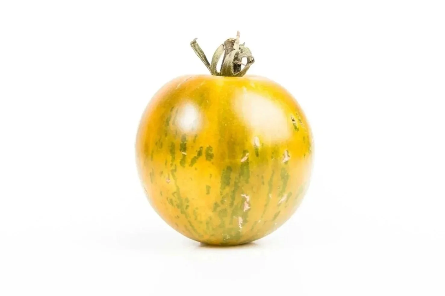 Yellow and green striped tomato with a green stem on a white background.