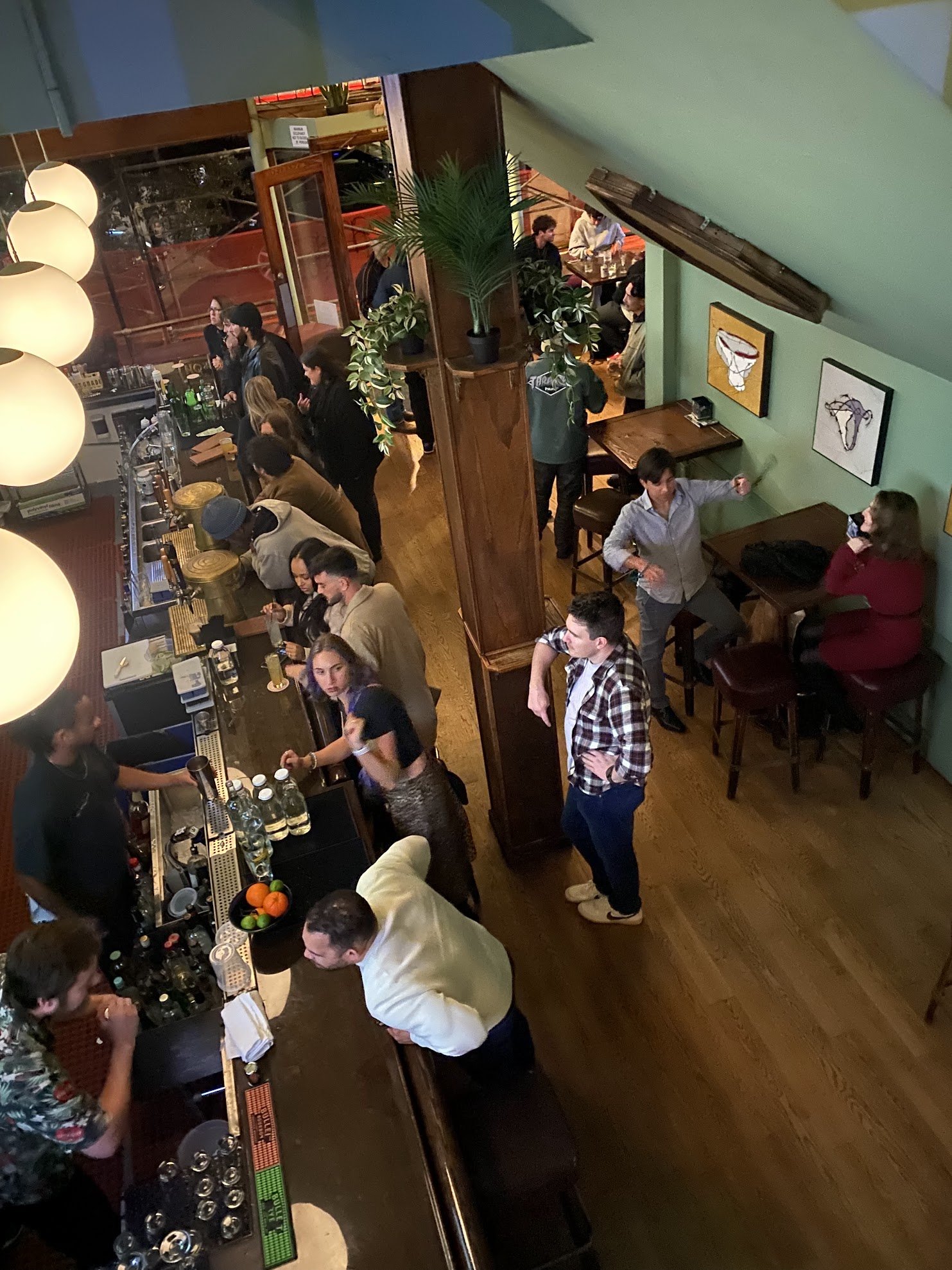 warm, inviting, clean bar space with art on the walls taken from the upstairs lounge