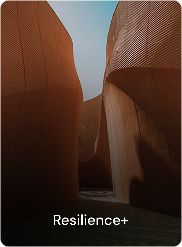 A woman stands at the edge of an infinity pool overlooking a sea of clouds and a colorful sunset sky.