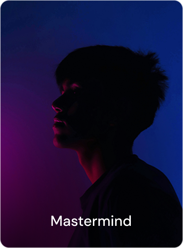 A close-up portrait of a confident man outdoors with a blurred background of greenery, sunlight highlighting his face