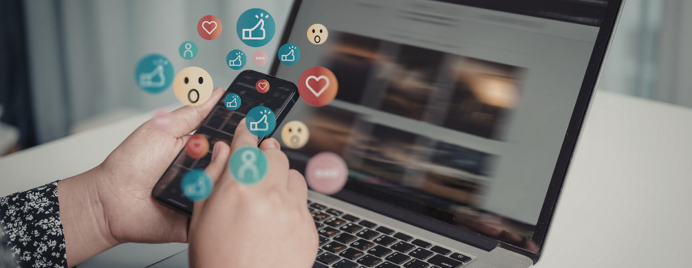 A person is holding a smartphone displaying various social media icons such as hearts, likes, interactions from short clips