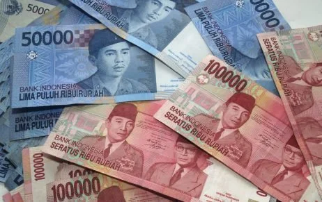 Various Indonesian banknotes in denominations of 50,000, 10,000, and 5,000 rupiah.