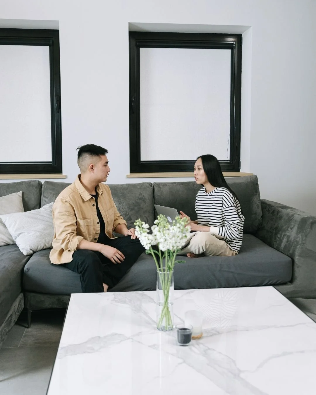 Couple having calm supportive conversation about sharing family responsibilities - Lisa Brooks Therapist Vancouver BC