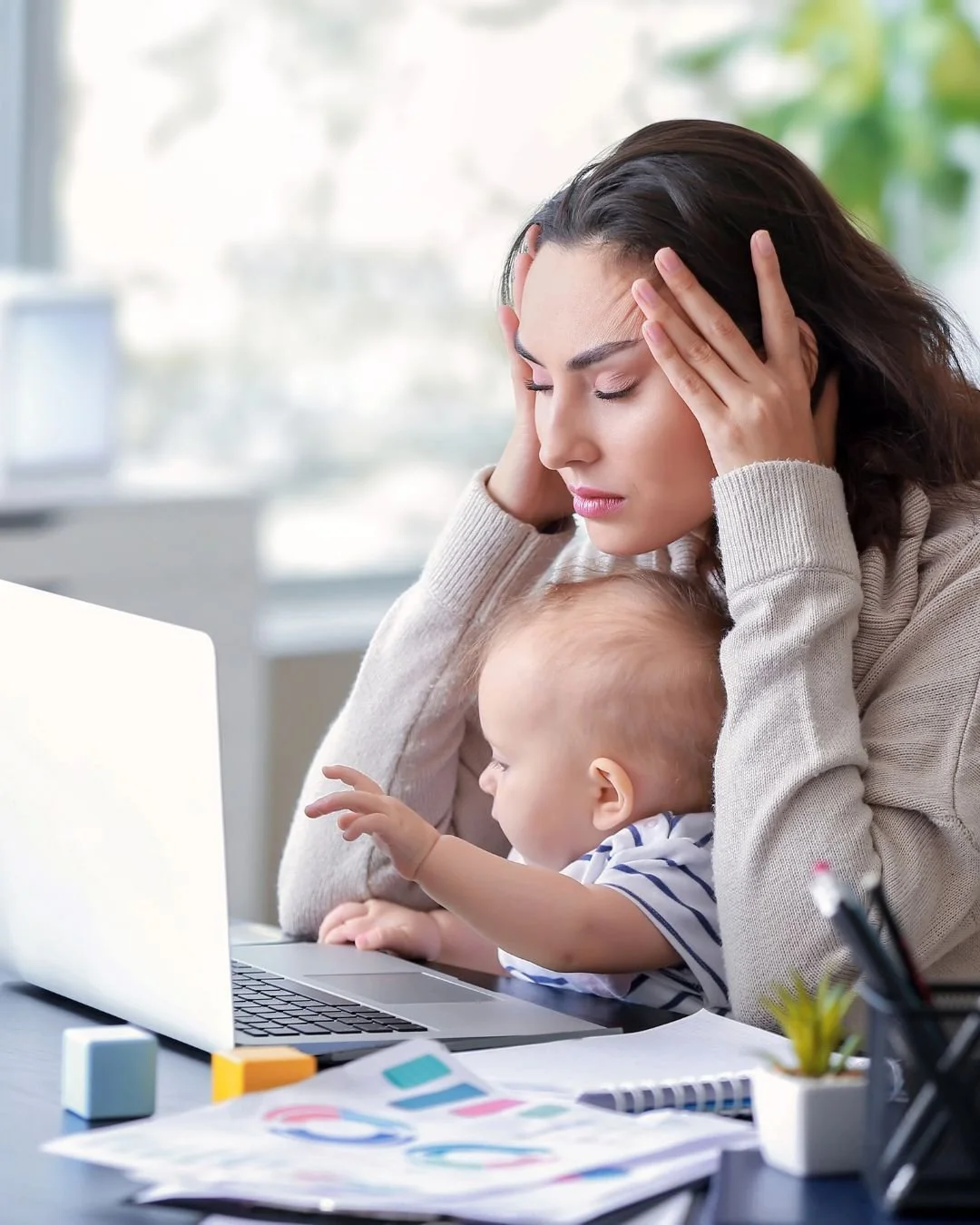 mom with baby on her lap stressed out