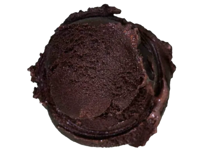 A close-up of a partially eaten chocolate ice cream bar or cupcake with a dark chocolate exterior.