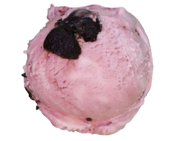 A scoop of pink strawberry ice cream with two blackberries on top.