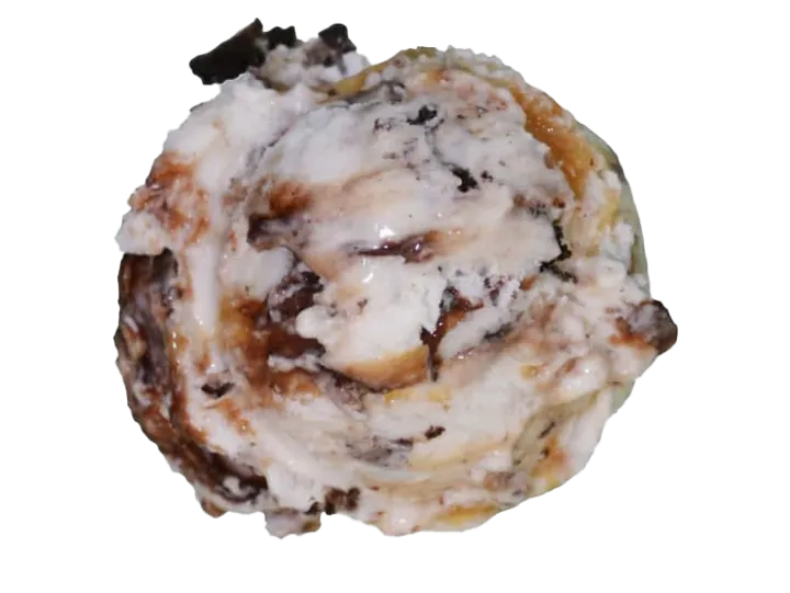 Close-up of a baked apple cinnamon roll with cream cheese frosting.