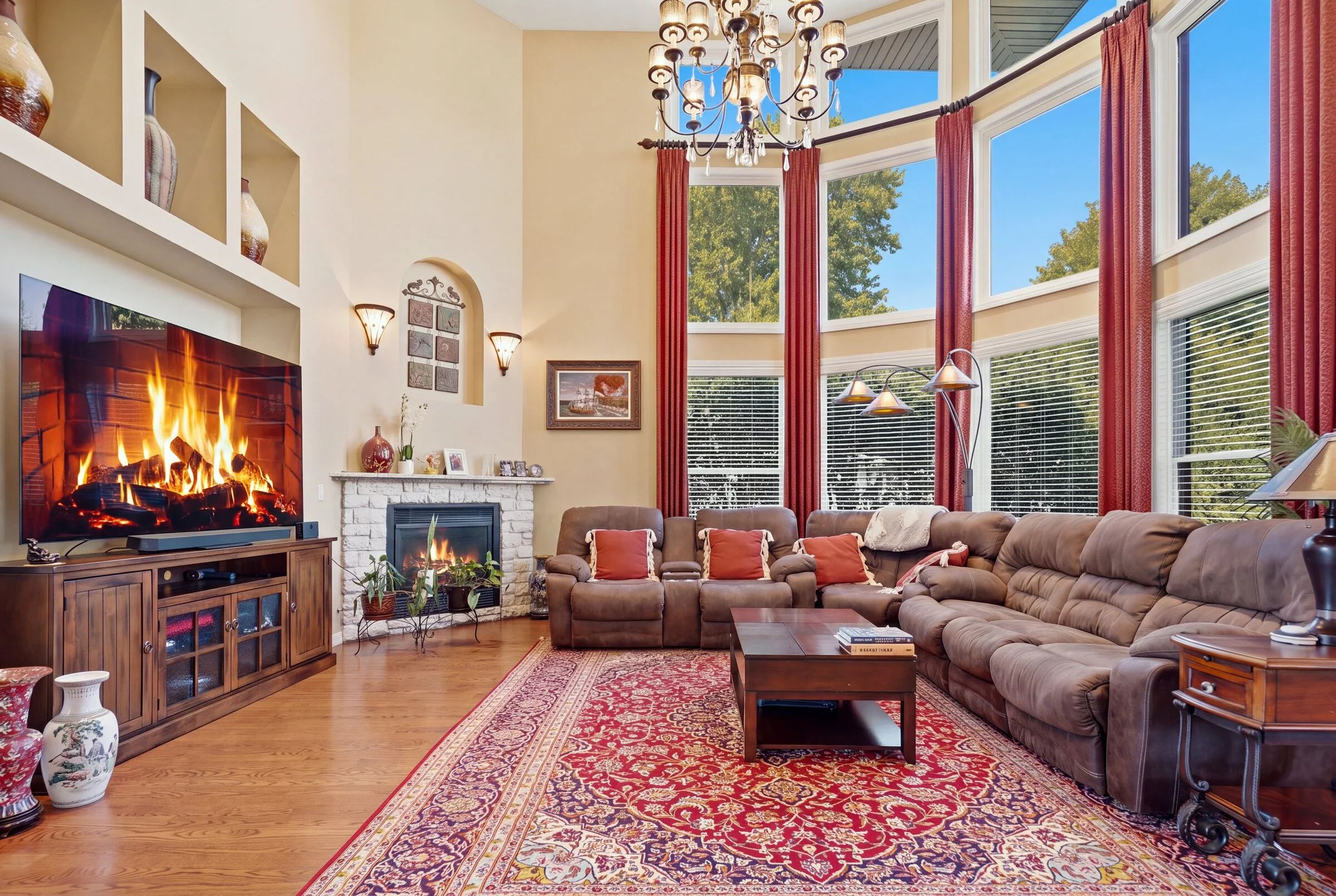 lincolnshire-two-story-family-room-curved-bay-windows-lit-fireplace.jpg